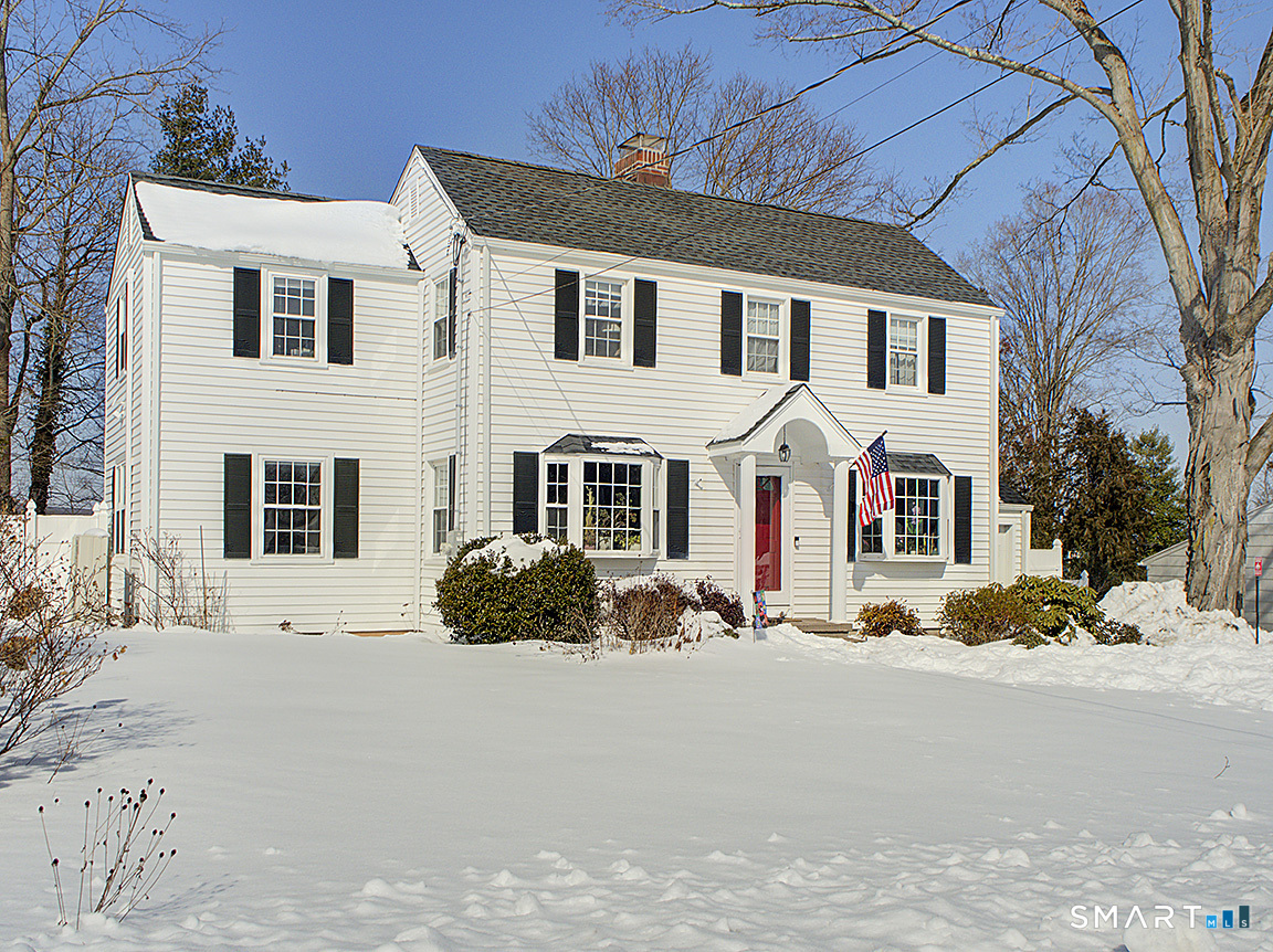 71 Vista Road North Haven, CT 06473 - Photo 4 of 32 a view of a white house with a yard covered in snow