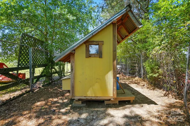 a view of a porch with wooden floor next to a yard