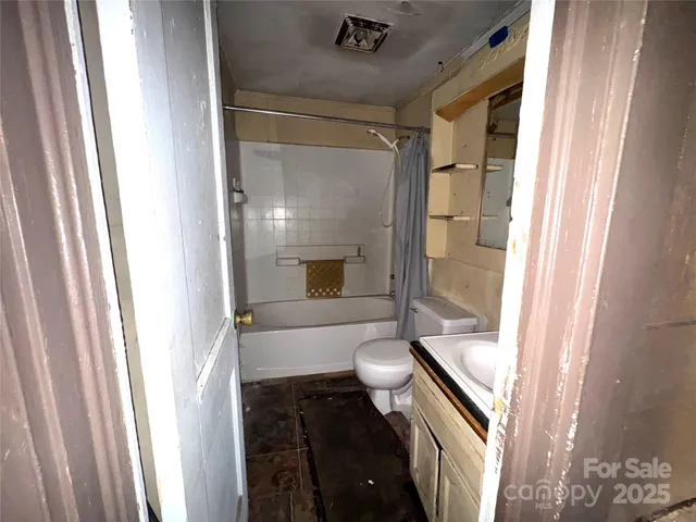 a bathroom with a granite countertop shower and a sink