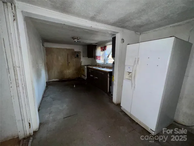 a view of a hallway to closet and utility room