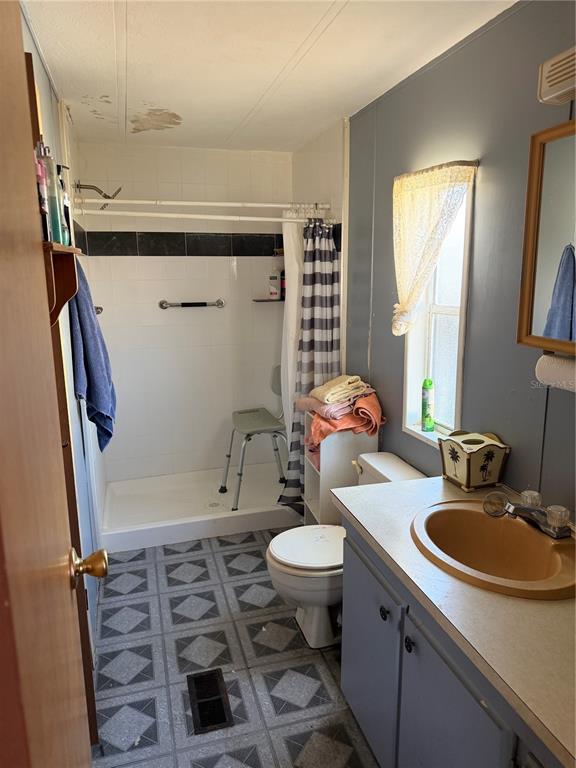 8156 North Princess Avenue Dunnellon, FL 34433 - Photo 18 of 26 a bathroom with a sink a toilet and shower