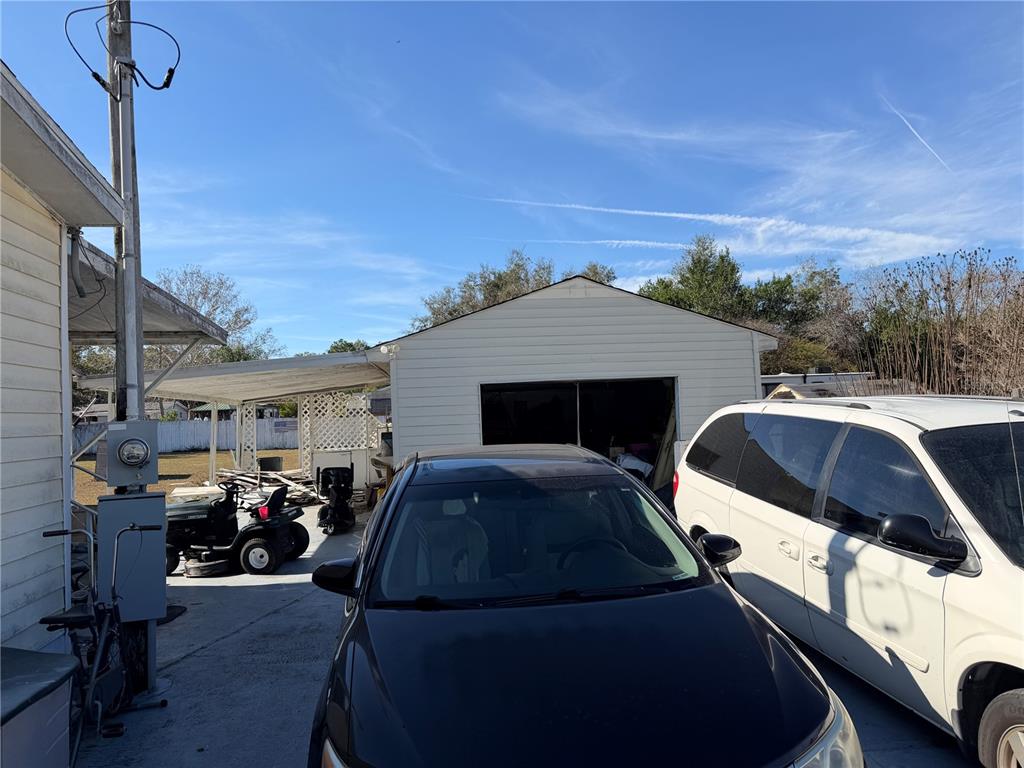 8156 North Princess Avenue Dunnellon, FL 34433 - Photo 21 of 26 a front view of a house with cars parked