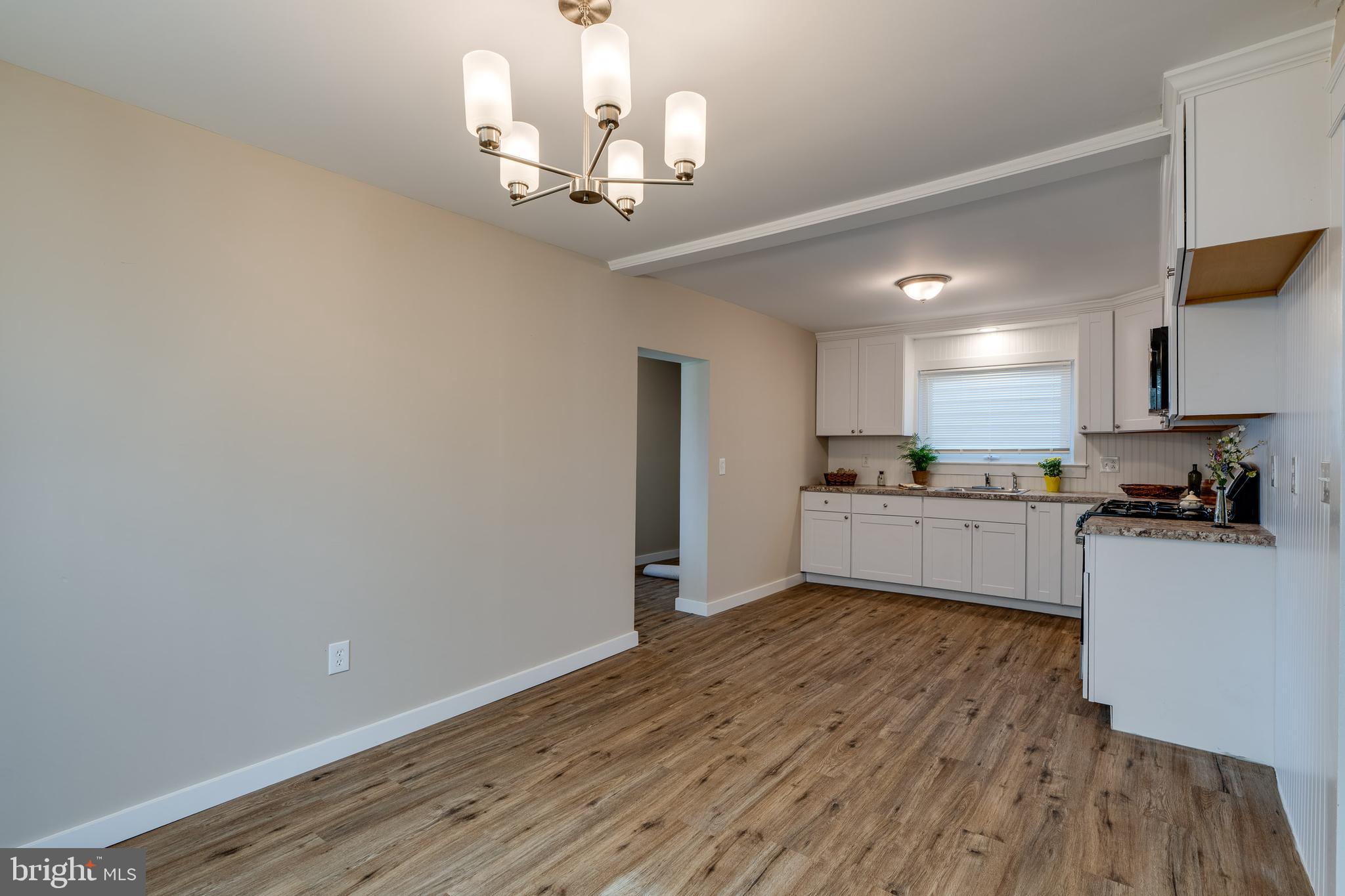 309 South Cherry Street Manheim, PA 17545 - Photo 11 of 34 a view of a kitchen with a sink and dishwasher a refrigerator with wooden floor
