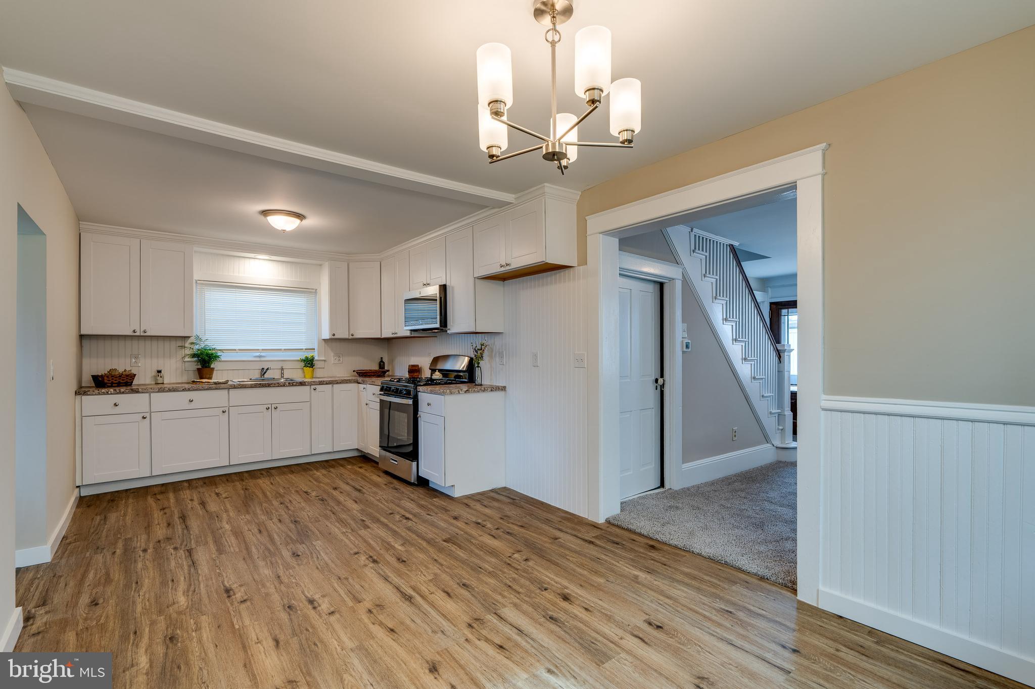 309 South Cherry Street Manheim, PA 17545 - Photo 12 of 34 a kitchen with stainless steel appliances granite countertop a refrigerator a stove top oven a sink dishwasher and white cabinets with wooden floor