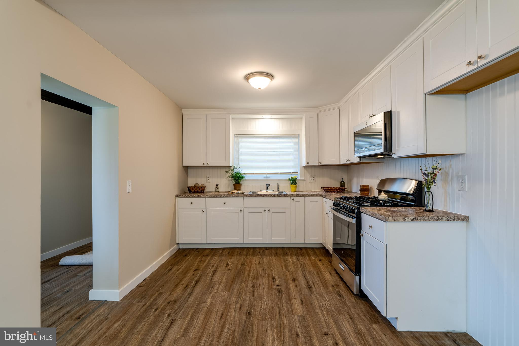 309 South Cherry Street Manheim, PA 17545 - Photo 13 of 34 a kitchen with wooden floors and white appliances