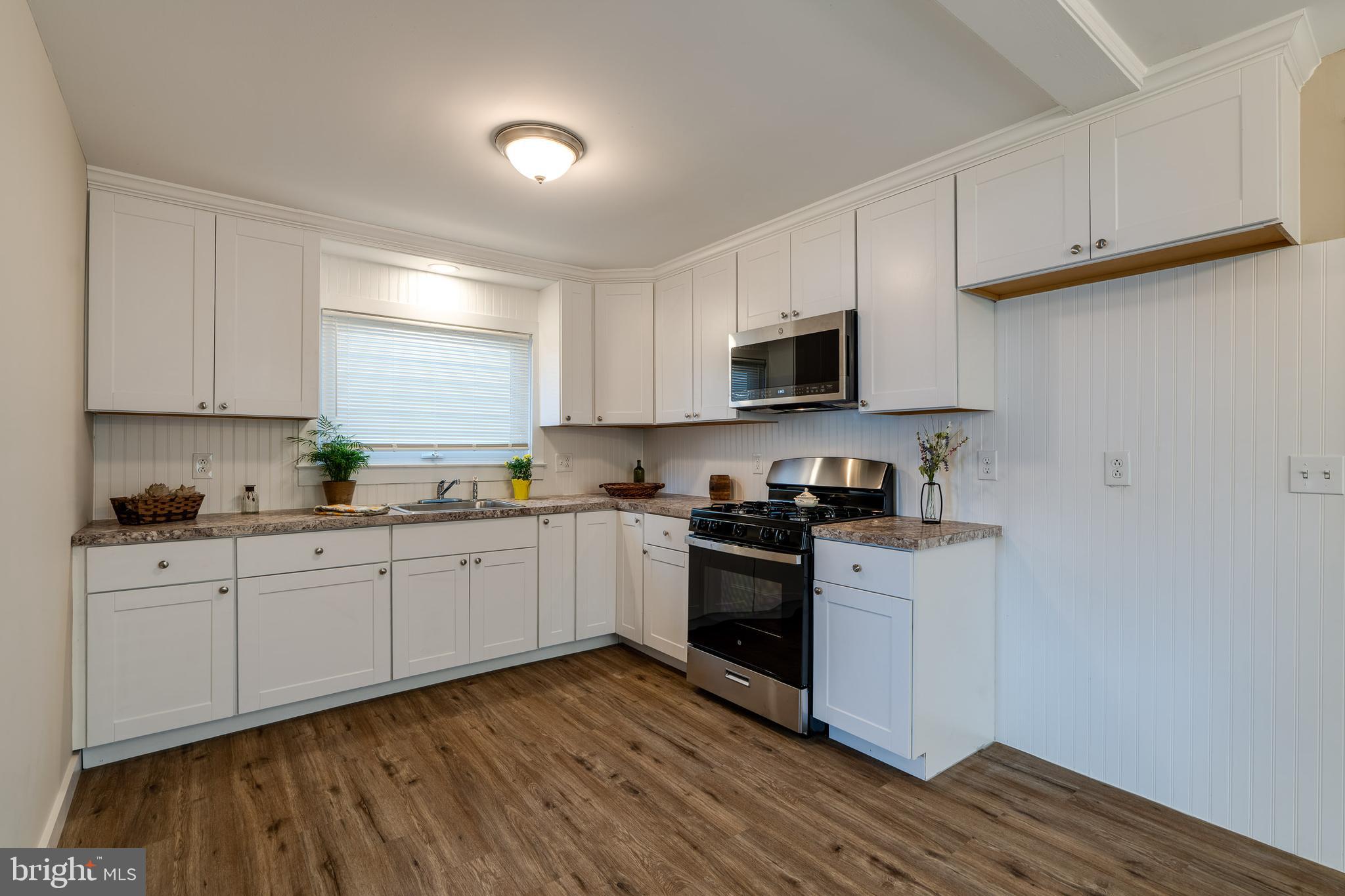 309 South Cherry Street Manheim, PA 17545 - Photo 14 of 34 a kitchen with granite countertop white cabinets and stainless steel appliances