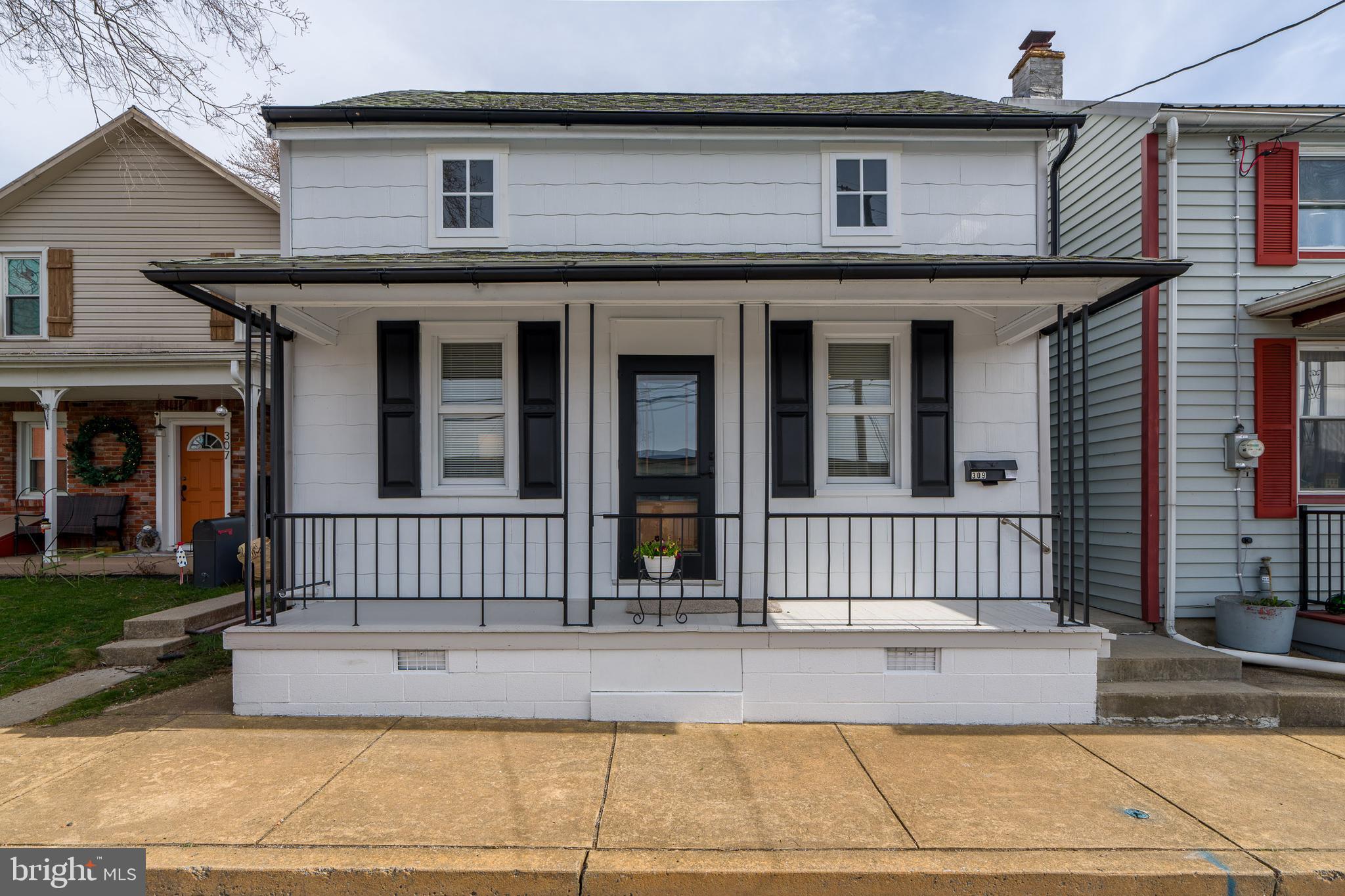 309 South Cherry Street Manheim, PA 17545 - Photo 3 of 34 a view of a house with a small deck and a floor to ceiling window and a yard