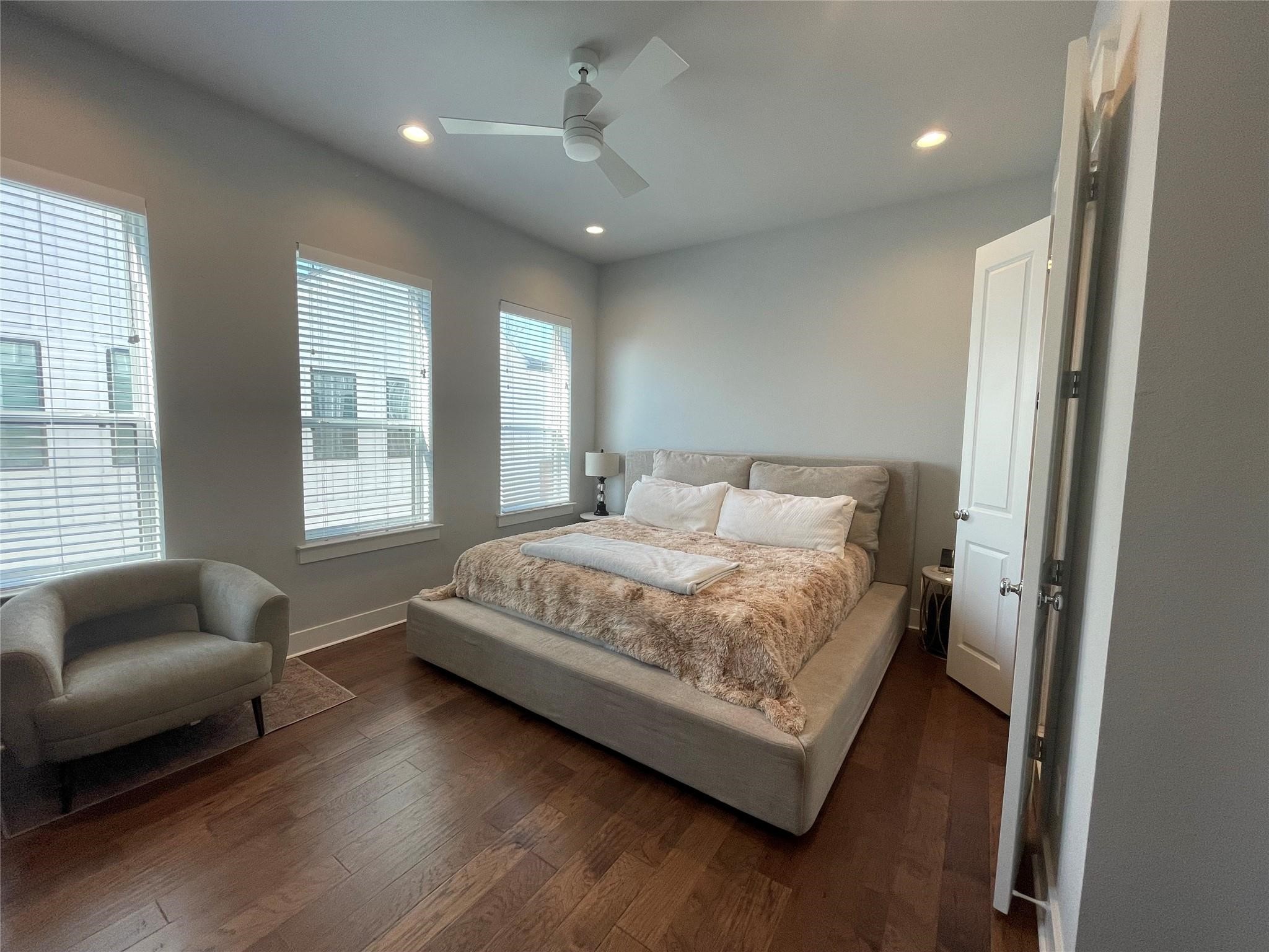 902 Martin Street, Unit A Houston, TX 77018 - Photo 17 of 21 a bedroom with a bed couch and windows