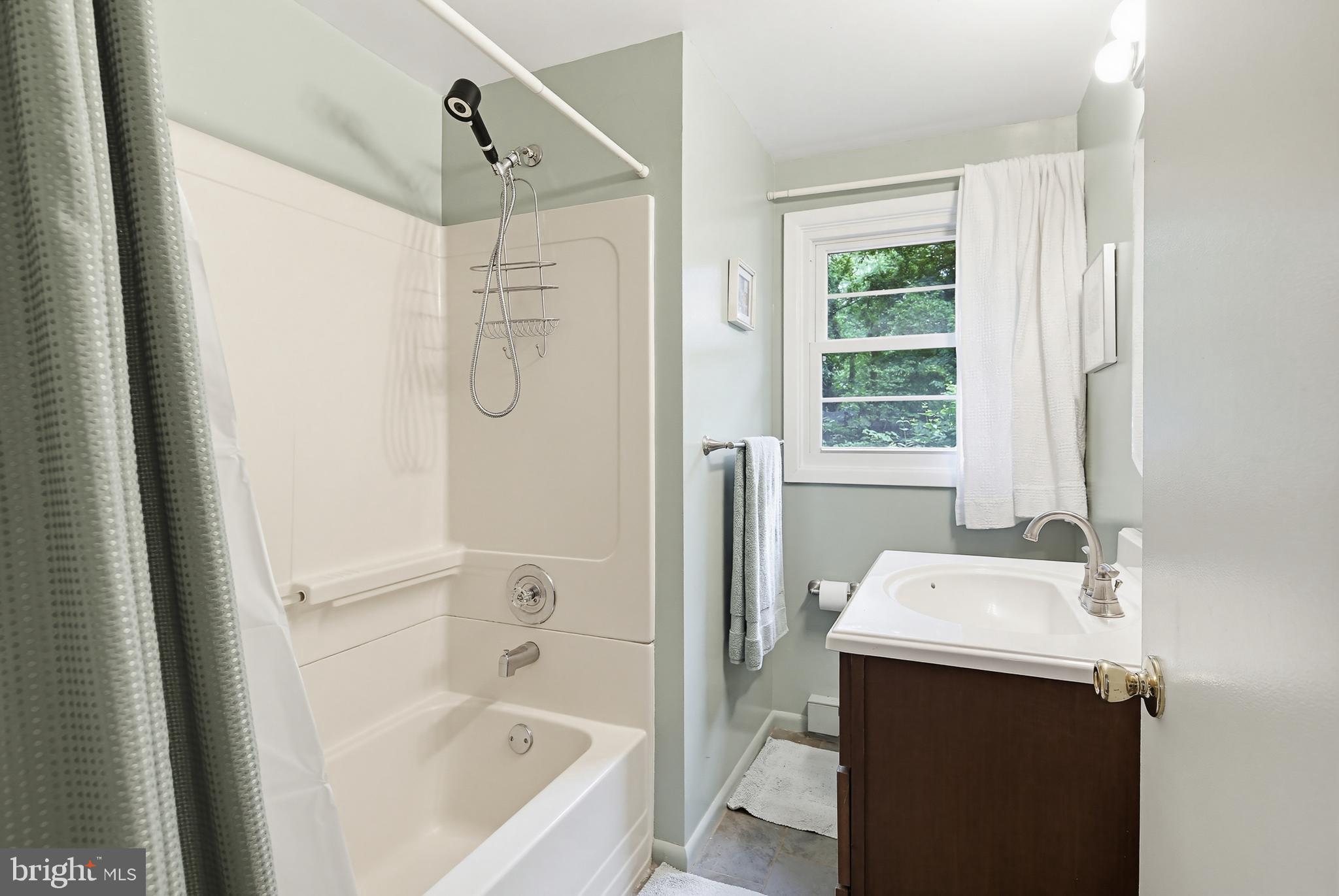 919 Blue Ridge Drive Annapolis, MD 21409 - Photo 18 of 30 a bathroom with a tub a sink and a window