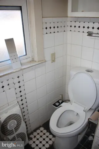 a view of hallway with closet and wooden floor