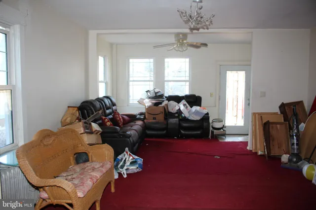 a living room with furniture and a chandelier