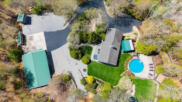 an aerial view of a house with a yard and trees
