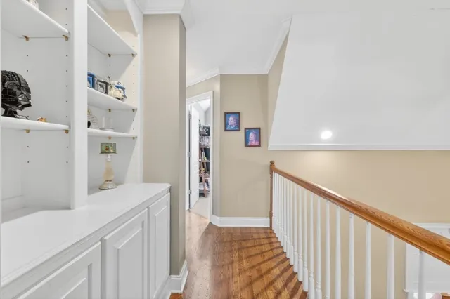 a view of a hallway with cabinet and door