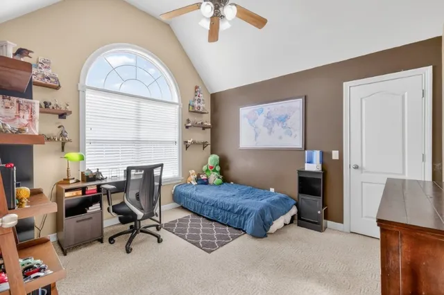 a bedroom with furniture and a window