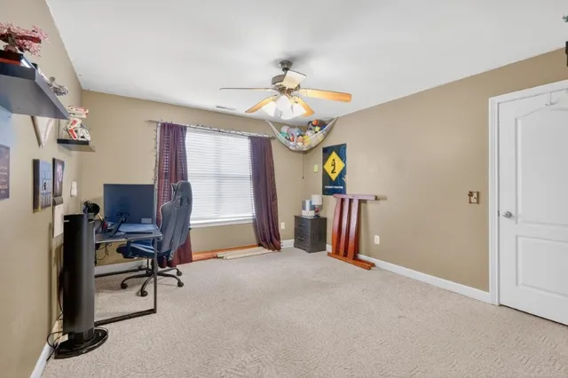 a view of a livingroom with workspace and a window