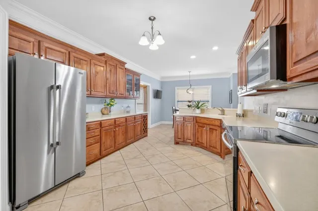 a kitchen with stainless steel appliances a refrigerator sink and cabinets
