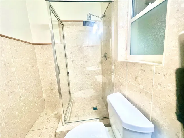 a bathroom with a toilet a sink and a shower