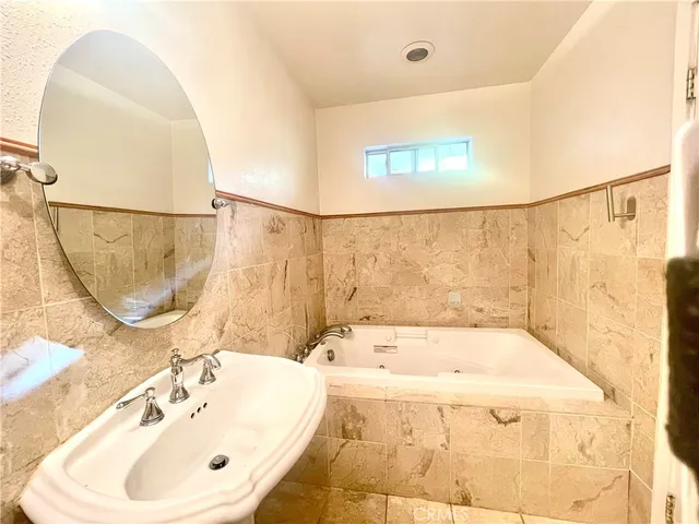 a bathroom with a sink toilet and mirror