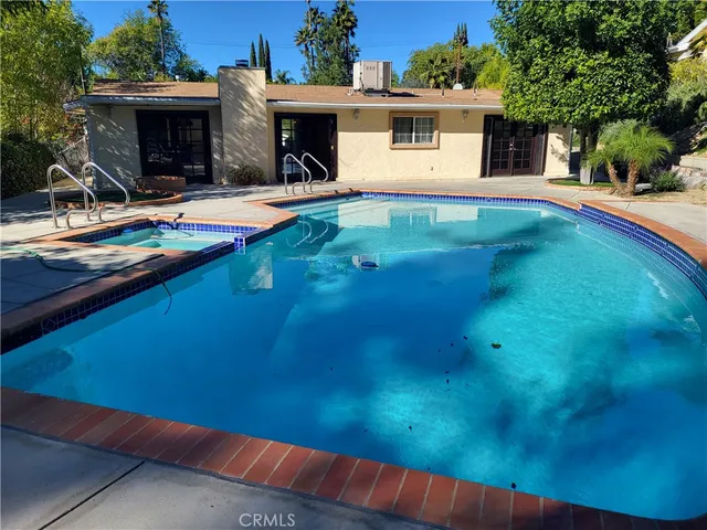 a view of a patio with table and chairs and potted plants