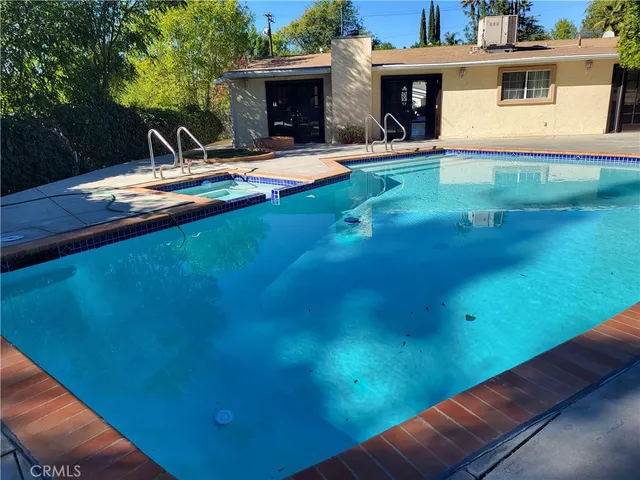 a view of a swimming pool with a yard