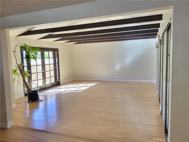 a view of a room with wooden floor and window