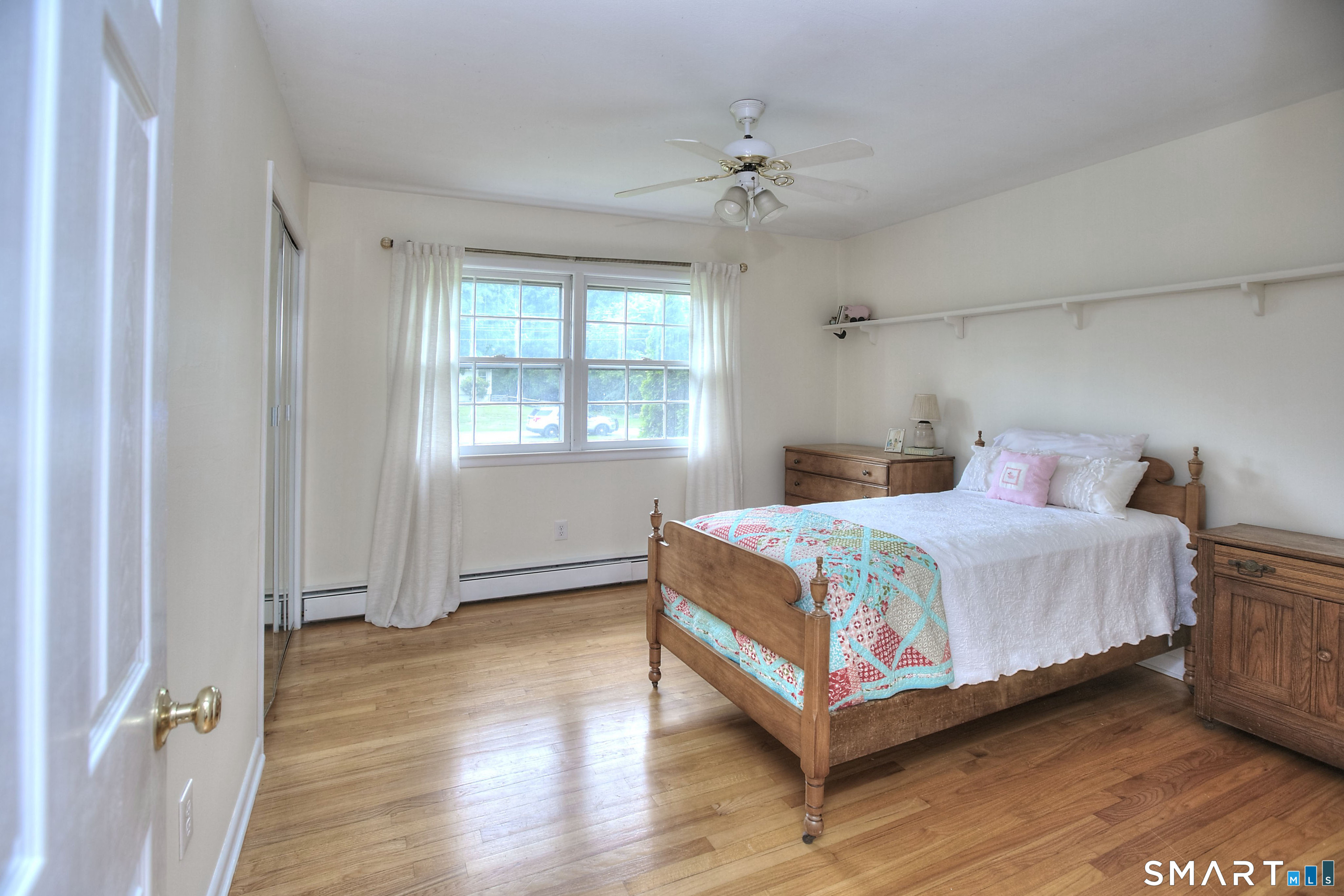 324 Ridge Road Orange, CT 06477 - Photo 29 of 38 a bedroom with a bed and wooden floor