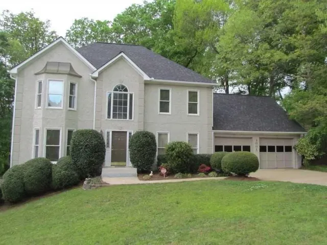 a front view of a house with a yard and garage