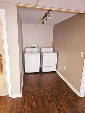 an empty room with wooden floor and closet