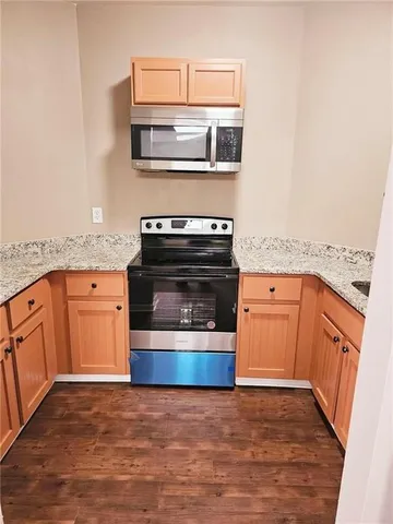 a kitchen with stainless steel appliances granite countertop a stove and a refrigerator