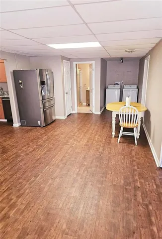 a view of a bedroom with wooden floor and furniture