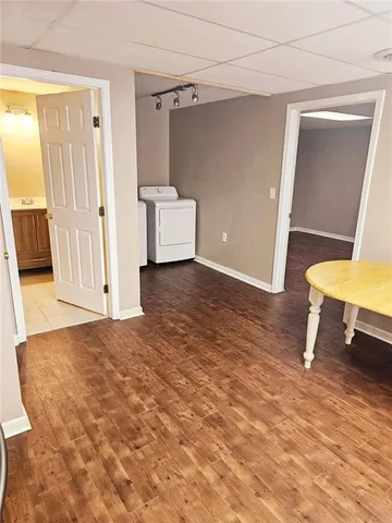 a view of entryway with a cabinet and a refrigerator