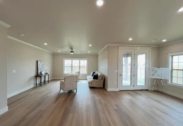 a living room with furniture and wooden floor