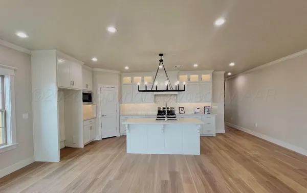 a kitchen with stainless steel appliances a refrigerator and a stove top oven