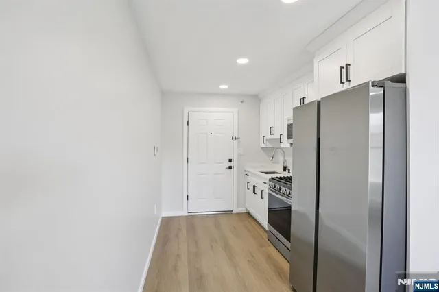 a kitchen with a refrigerator and a sink