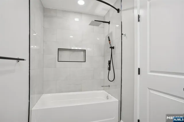 a bathroom with a bath tub and a shower