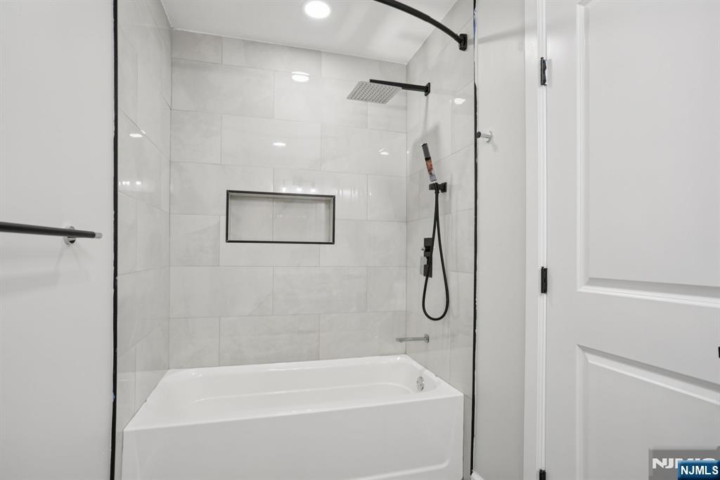 200-202 Summer Street, Unit 3 Paterson, NJ 07501 - Photo 10 of 12 a bathroom with a bath tub and a shower