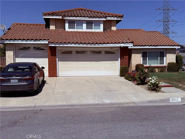 a front view of a house with a parking space