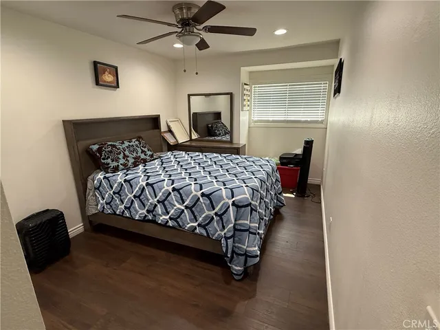 a bedroom with a bed mirror and window