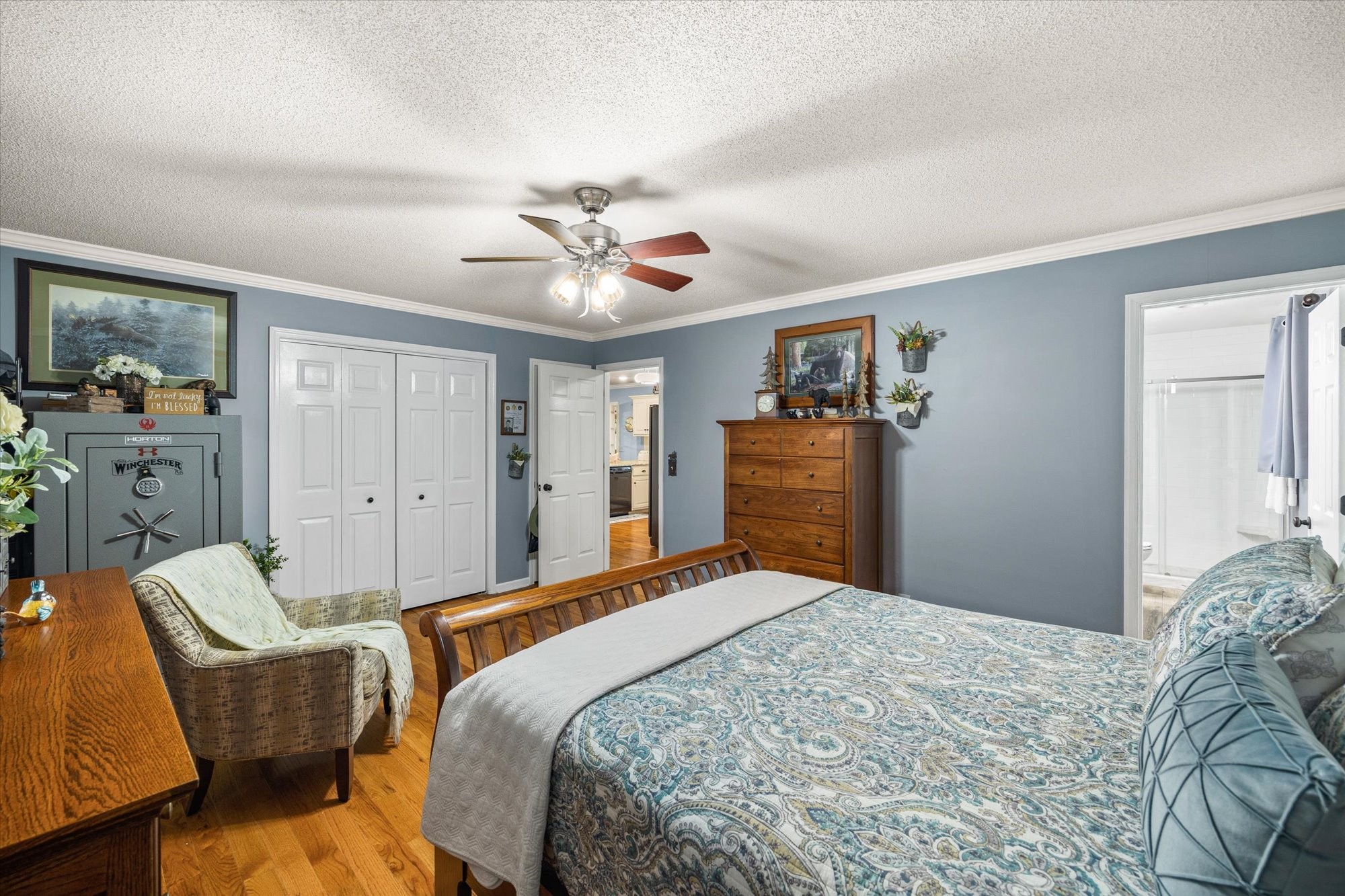 7214 Sarah Thomas Road Silver Point, TN 38582 - Photo 15 of 52 a bedroom with a large bed a chandelier and dresser