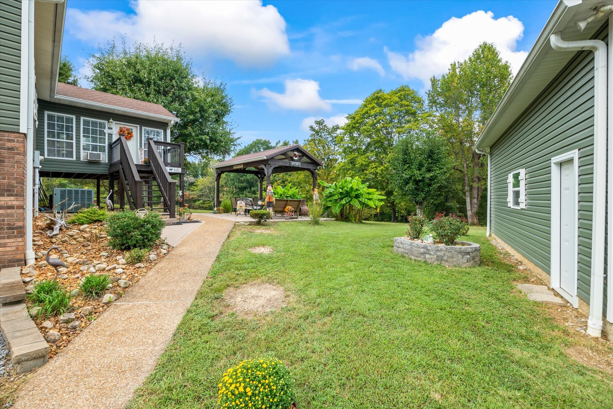 7214 Sarah Thomas Road Silver Point, TN 38582 - Photo 36 of 52 a view of a backyard with a garden and plants