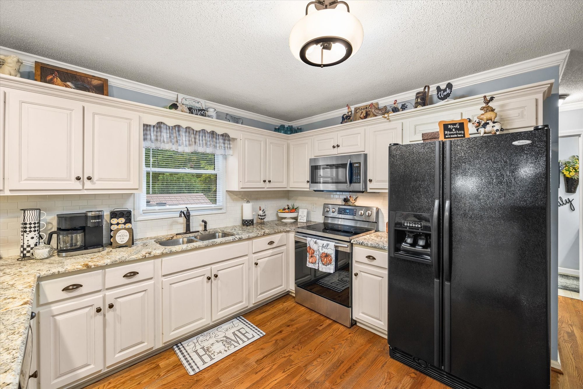 7214 Sarah Thomas Road Silver Point, TN 38582 - Photo 7 of 52 a kitchen with stainless steel appliances a refrigerator sink and cabinets