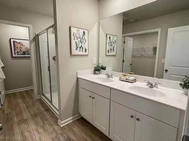 115 Wynn Way Pendergrass, GA 30567 - Photo 11 of 22 a bathroom with a double vanity sink mirror and shower