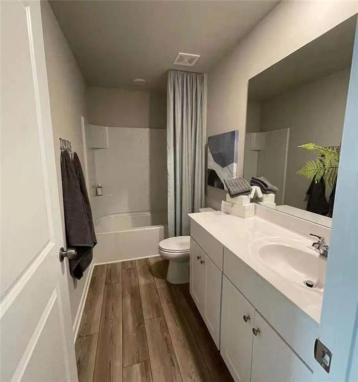 115 Wynn Way Pendergrass, GA 30567 - Photo 13 of 22 a bathroom with a sink a toilet a mirror and shower