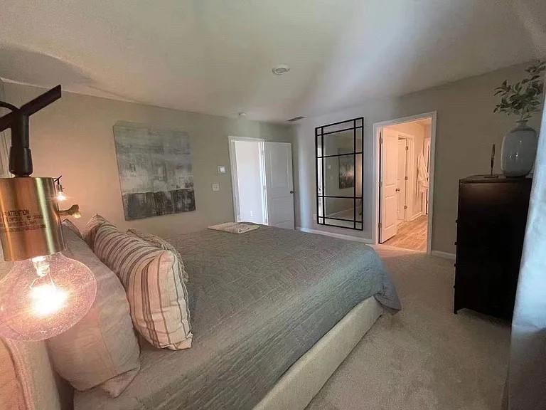115 Wynn Way Pendergrass, GA 30567 - Photo 18 of 22 a bedroom with a bed and wooden floor