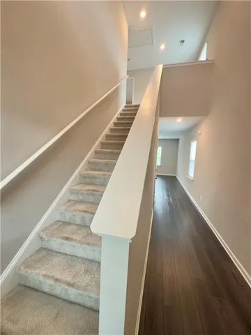 a view of entryway and hall with wooden floor