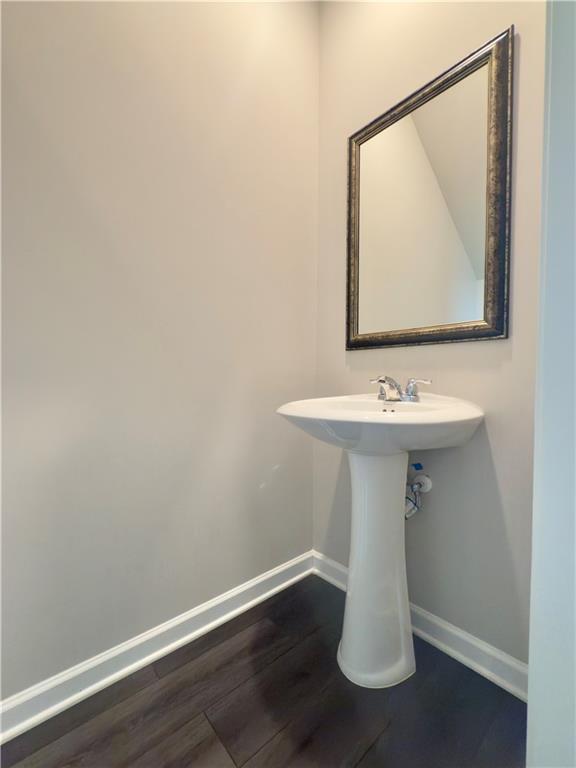 115 Wynn Way Pendergrass, GA 30567 - Photo 4 of 22 a bathroom with a sink a mirror and vanity
