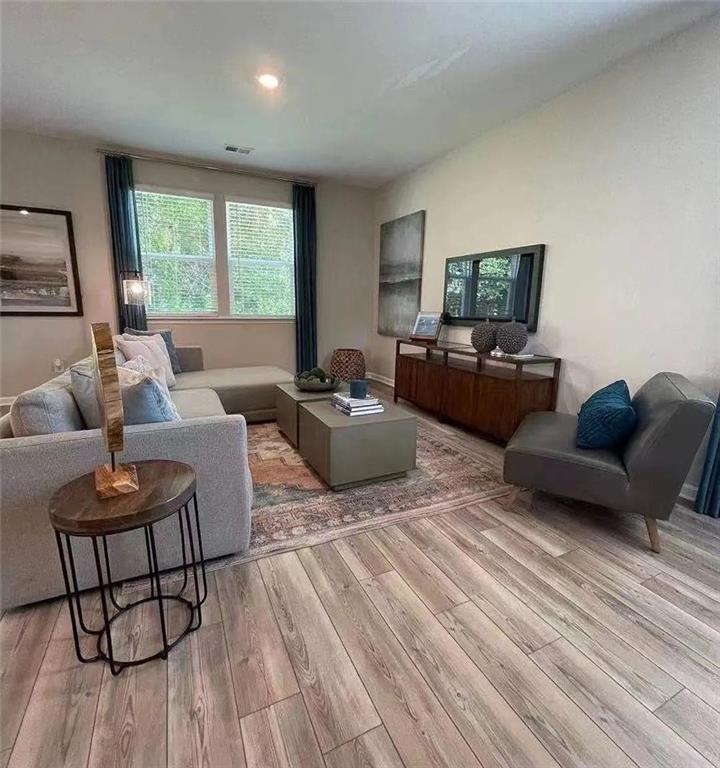 115 Wynn Way Pendergrass, GA 30567 - Photo 5 of 22 a living room with furniture and a large window