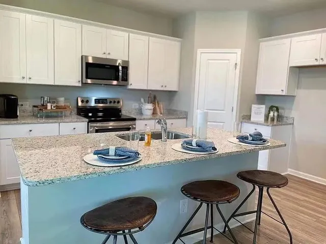 a kitchen with a stove and a microwave