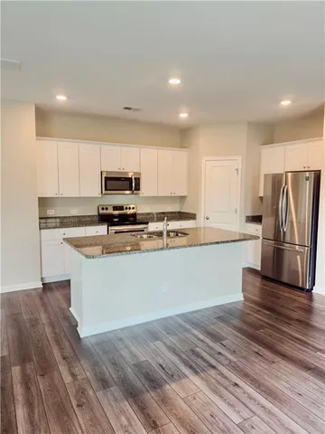 a white toilet sitting next to a small bathroom