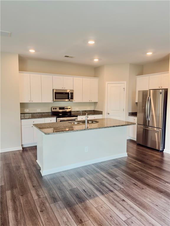 115 Wynn Way Pendergrass, GA 30567 - Photo 8 of 22 a kitchen with stainless steel appliances granite countertop a refrigerator a stove top oven a sink and dishwasher